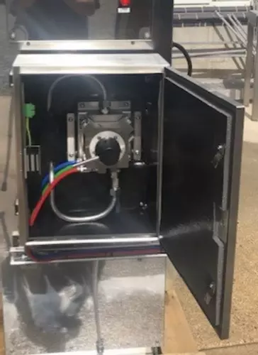Close-up view of the Kothar Turn & Clean system installed within the cabinet. This unit allows seamless switching between multiple detergents, enabling a controlled 3-stage cleaning process for effective vehicle washdown.